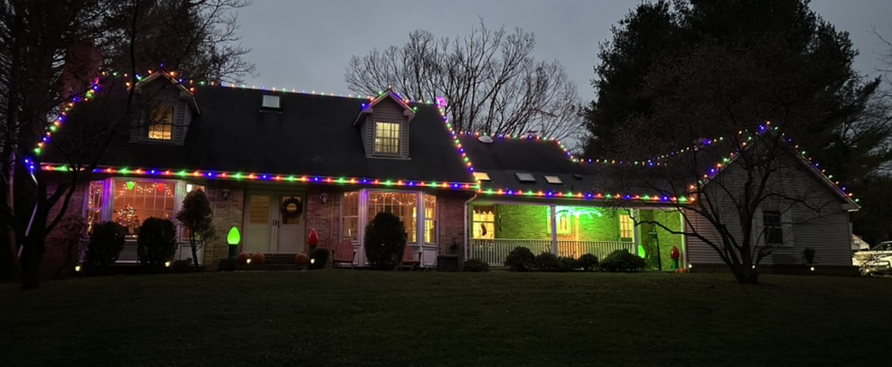 Custom seasonal roofline lighting on a Maryland home
